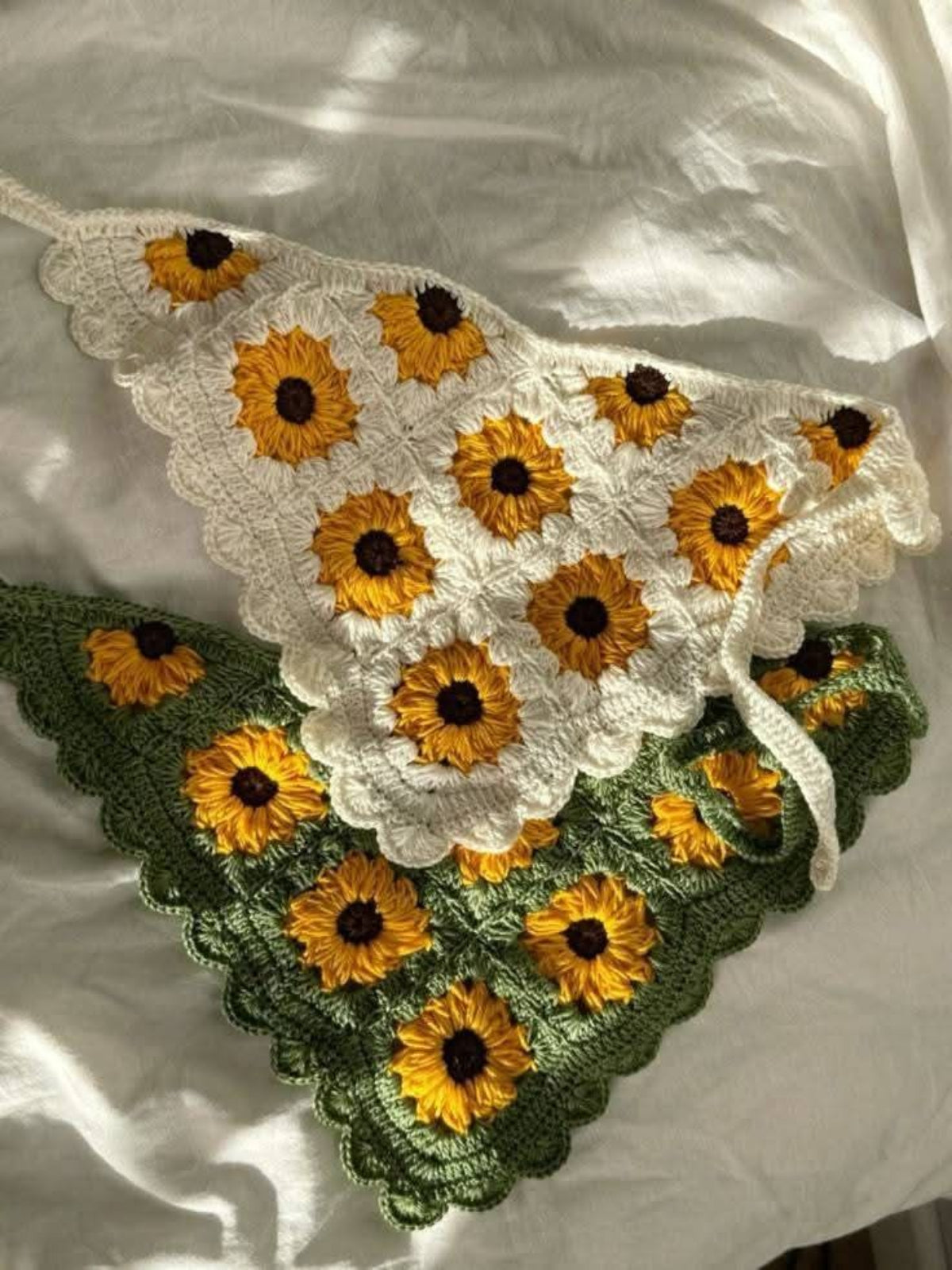 Crocheted sunflower patterned bandana on a white background
