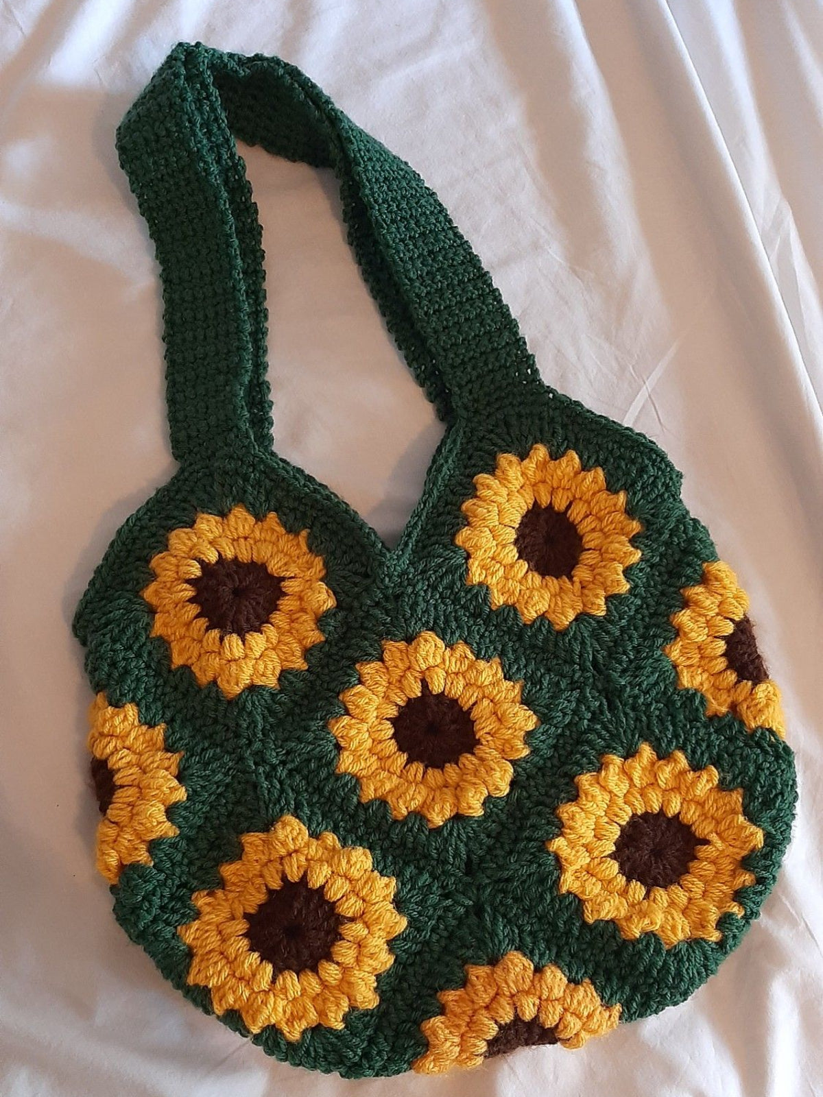 Crocheted bag with sunflower pattern on a white background