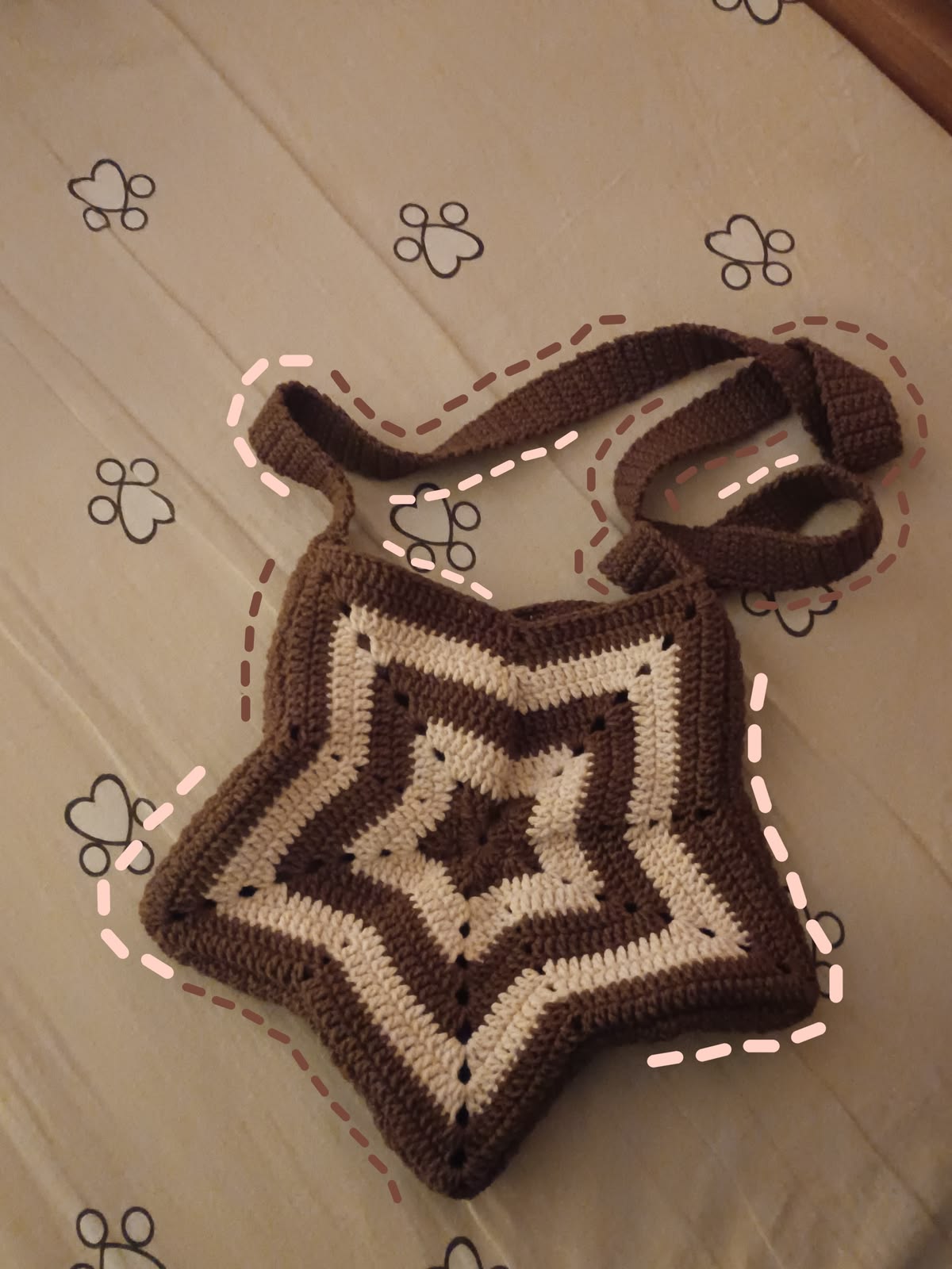 Crocheted bag with a geometric pattern on a light-colored floor.