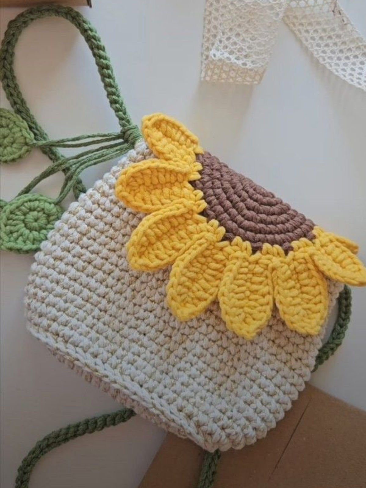 Crocheted bag with sunflower design on a white background